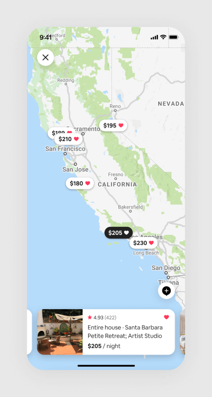A screenshot of Airbnb's Wishlist map view with several saved listings along the coast of California